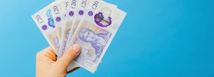 image womans hands which holds british pounds in her hands isolated over blue studio.jpg s1024x1024wisk20cEgVIT3pUOJ3ect7rCCx24sh8LMYNUY RoGPJkX3HWU4 | Mastering your payroll: in-house vs outsourced