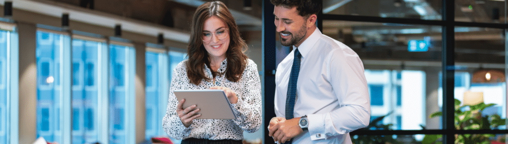 Two accountants in the office looking at tax software on a tablet device
