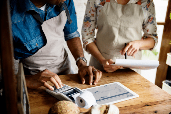 business owners discussing electronic payslips and paper payslips